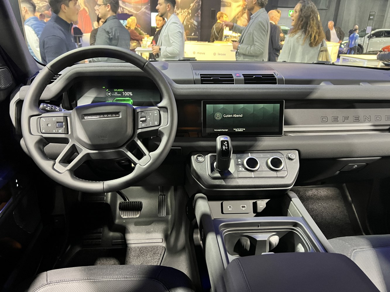 Dashboard and steering wheel with digital displays, gear selector and controls