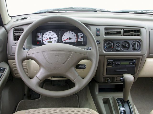 Steering wheel, dashboard with gauges, and central control panel
