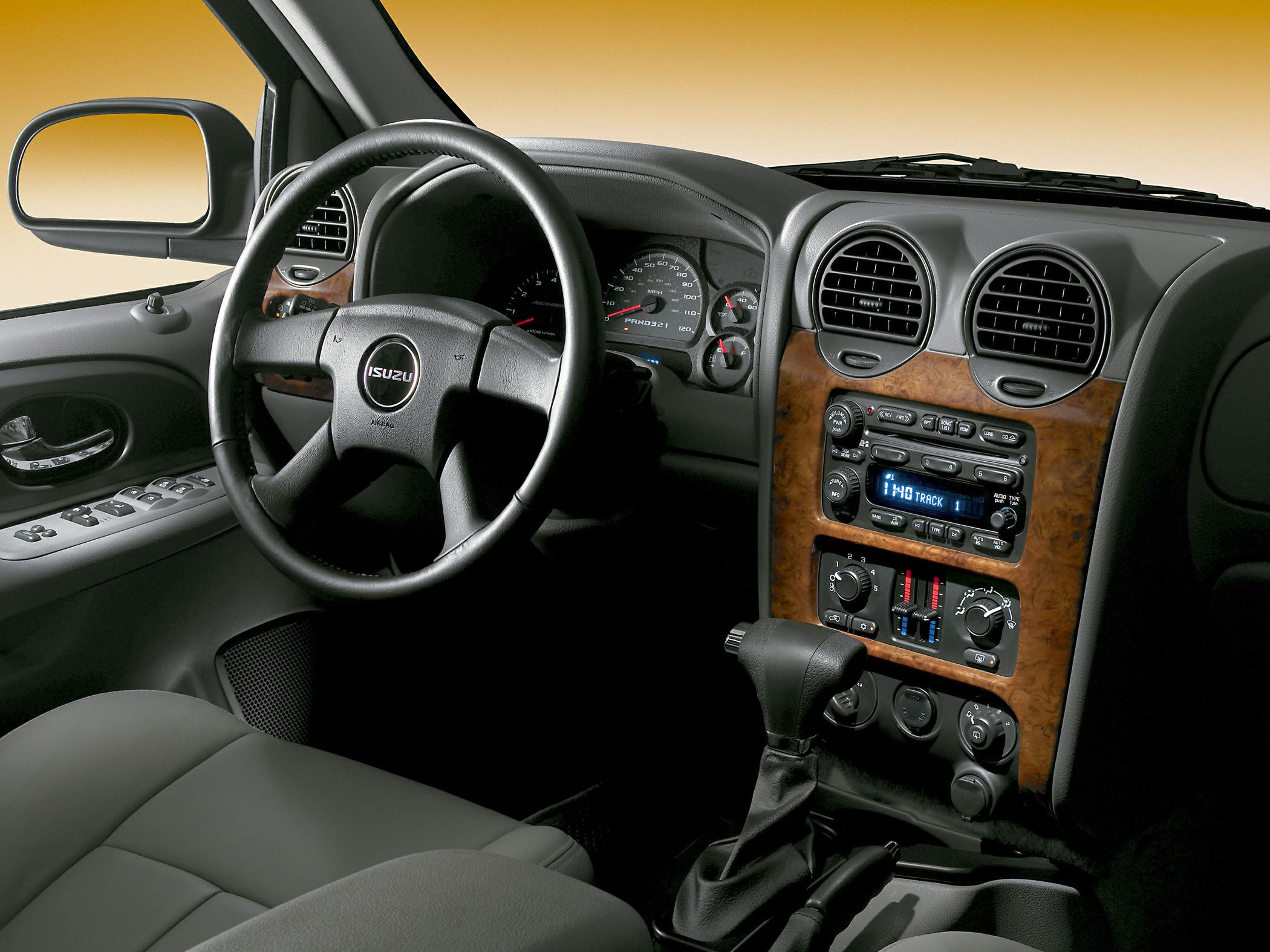 Dashboard with wood trim, steering wheel, and audio controls