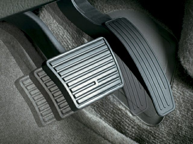 Close-up of accelerator and brake pedals with textured surfaces