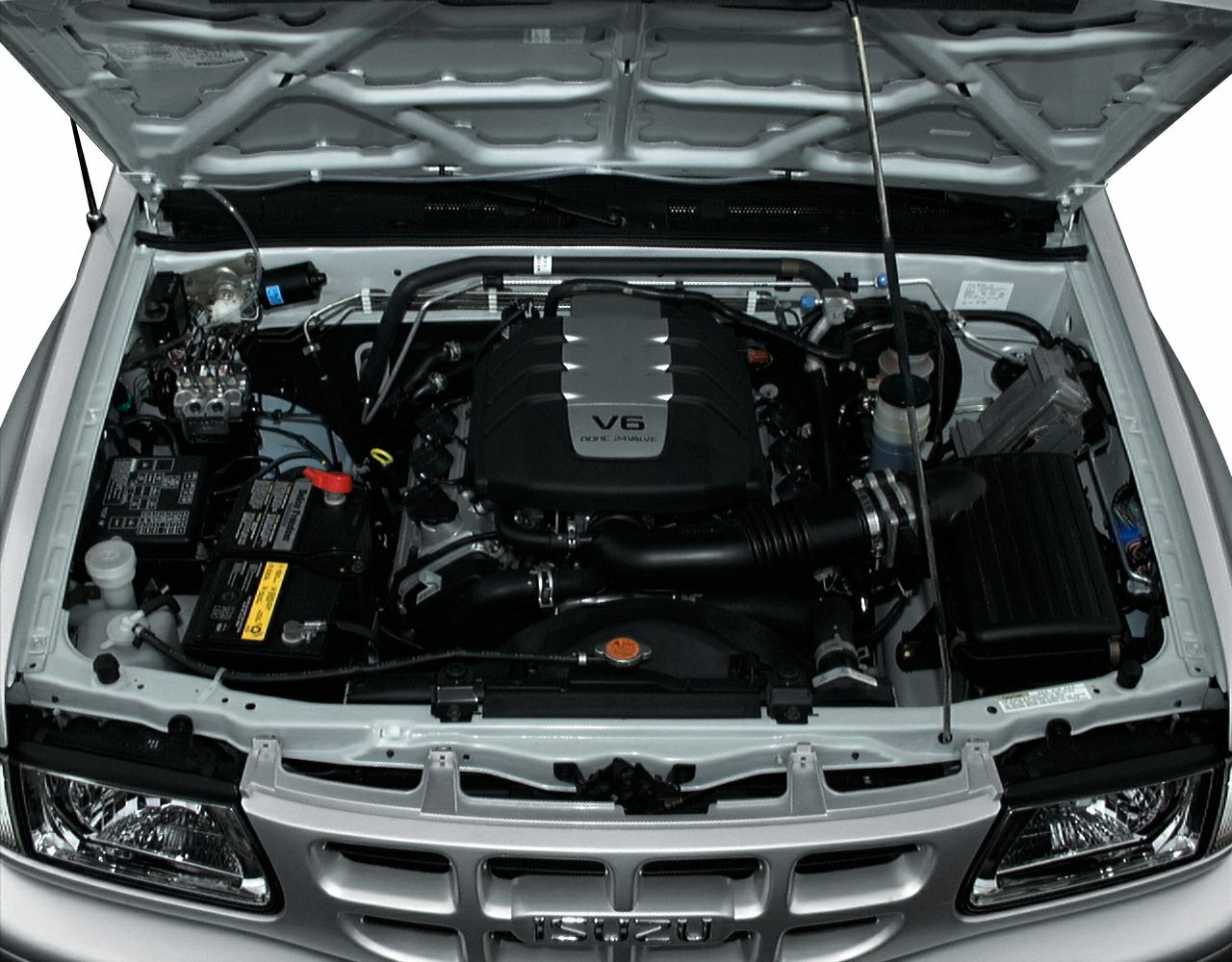 V6 engine compartment with detailed components and front grille.