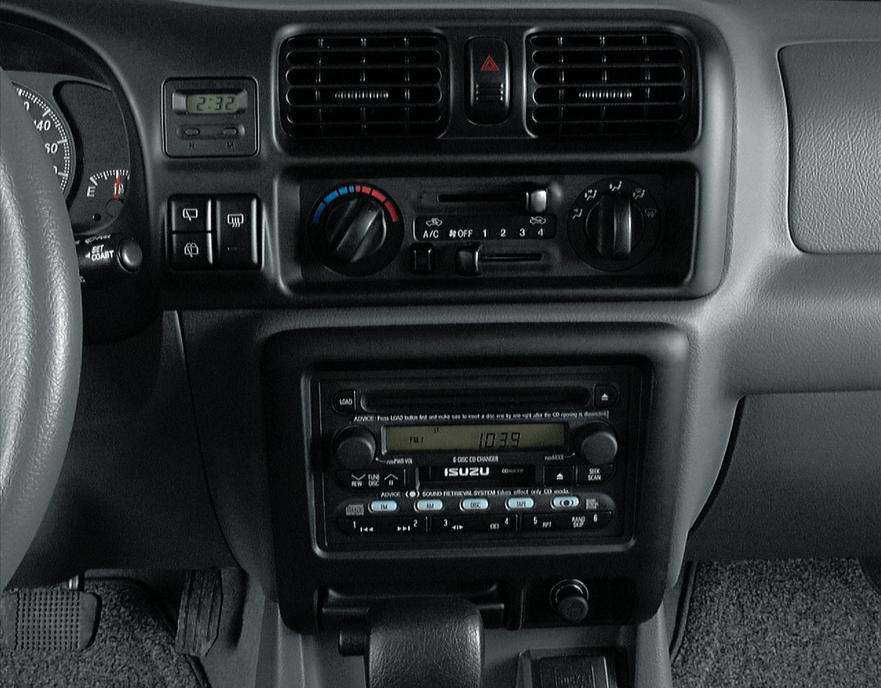 Dashboard with ventilation controls, clock, and audio system