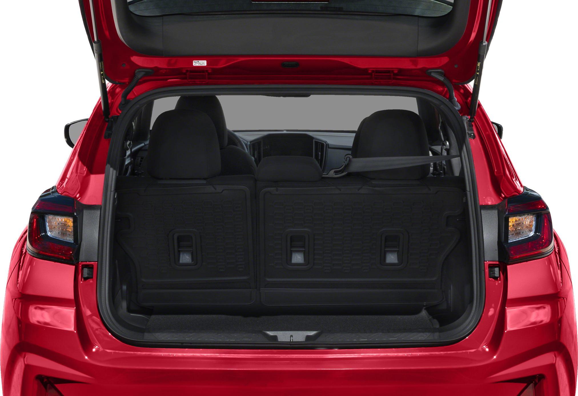 Rear cargo space and open tailgate of a hatchback.