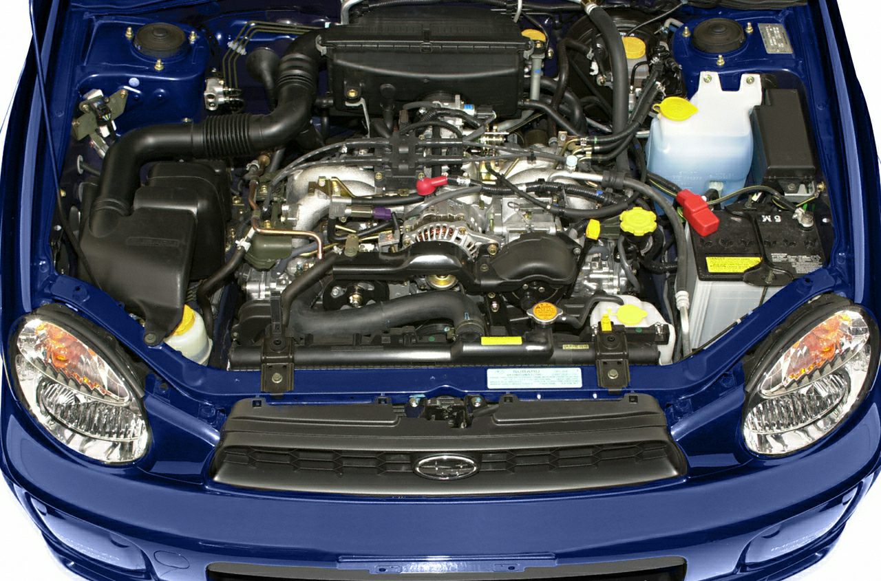 Boxer engine and detailed engine bay components of a car.