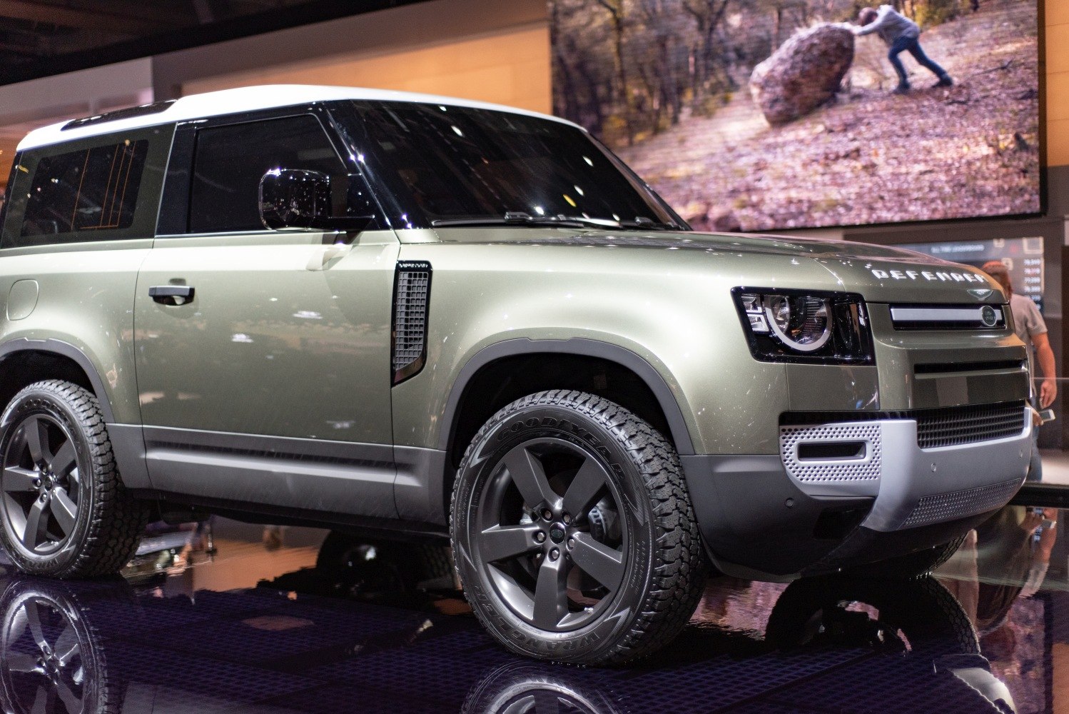 Front side view of a rugged SUV with modern headlights and all-terrain tires