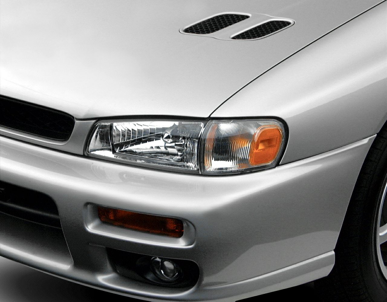 Front headlight with turn signal, hood vent, and fog light on compact coupe