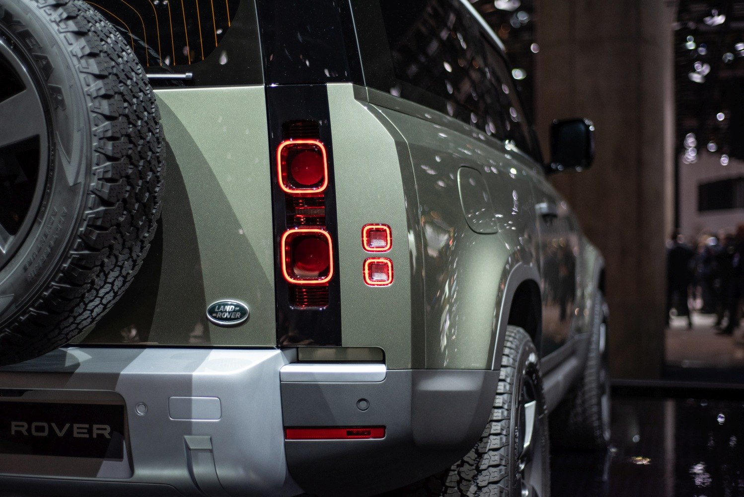 Rear design and tail lights of rugged SUV with spare tire and Land Rover badge