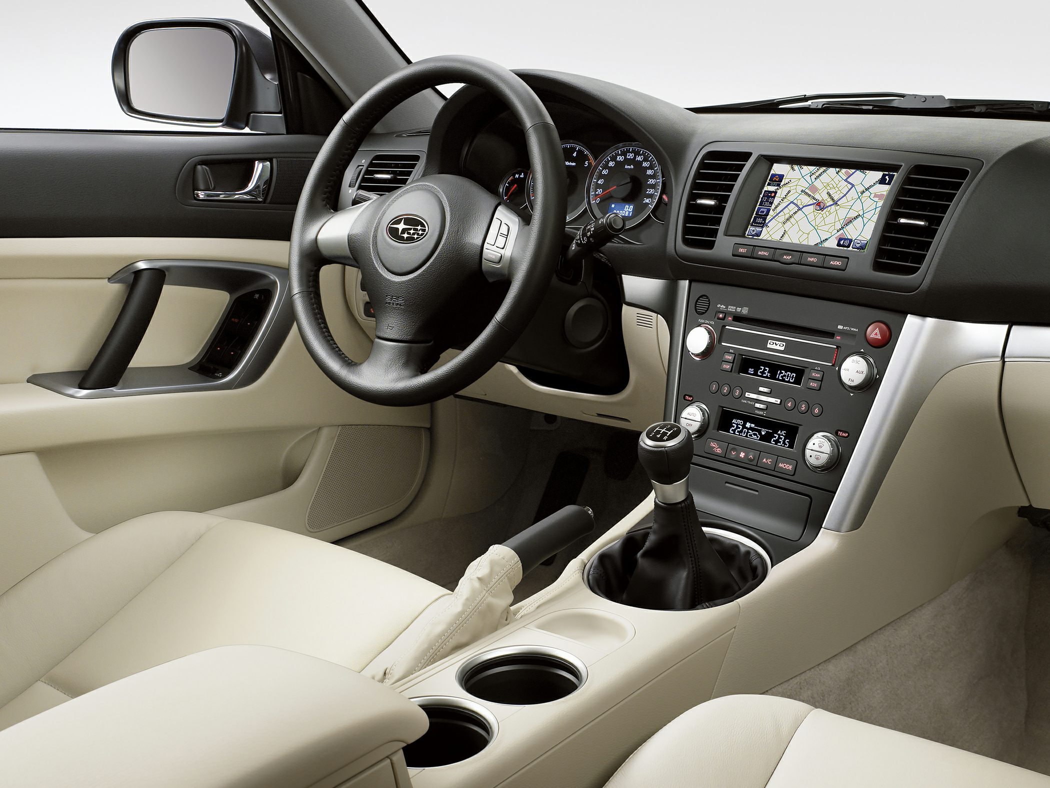 Manual transmission gear shift with navigation screen and multi-function steering wheel.
