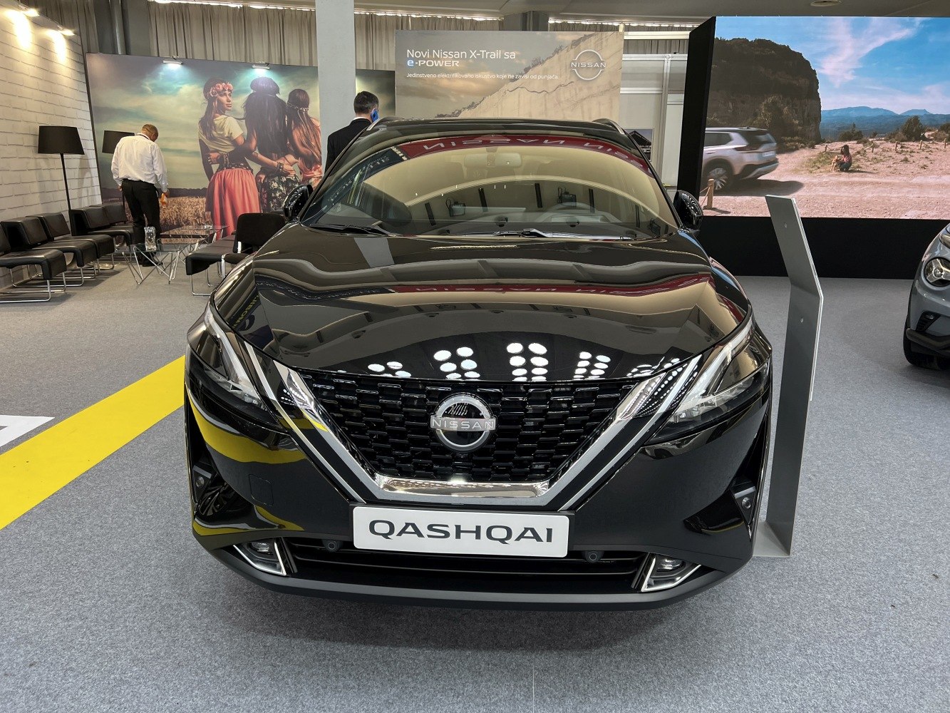 Front view of a car with bold grille and sleek headlights