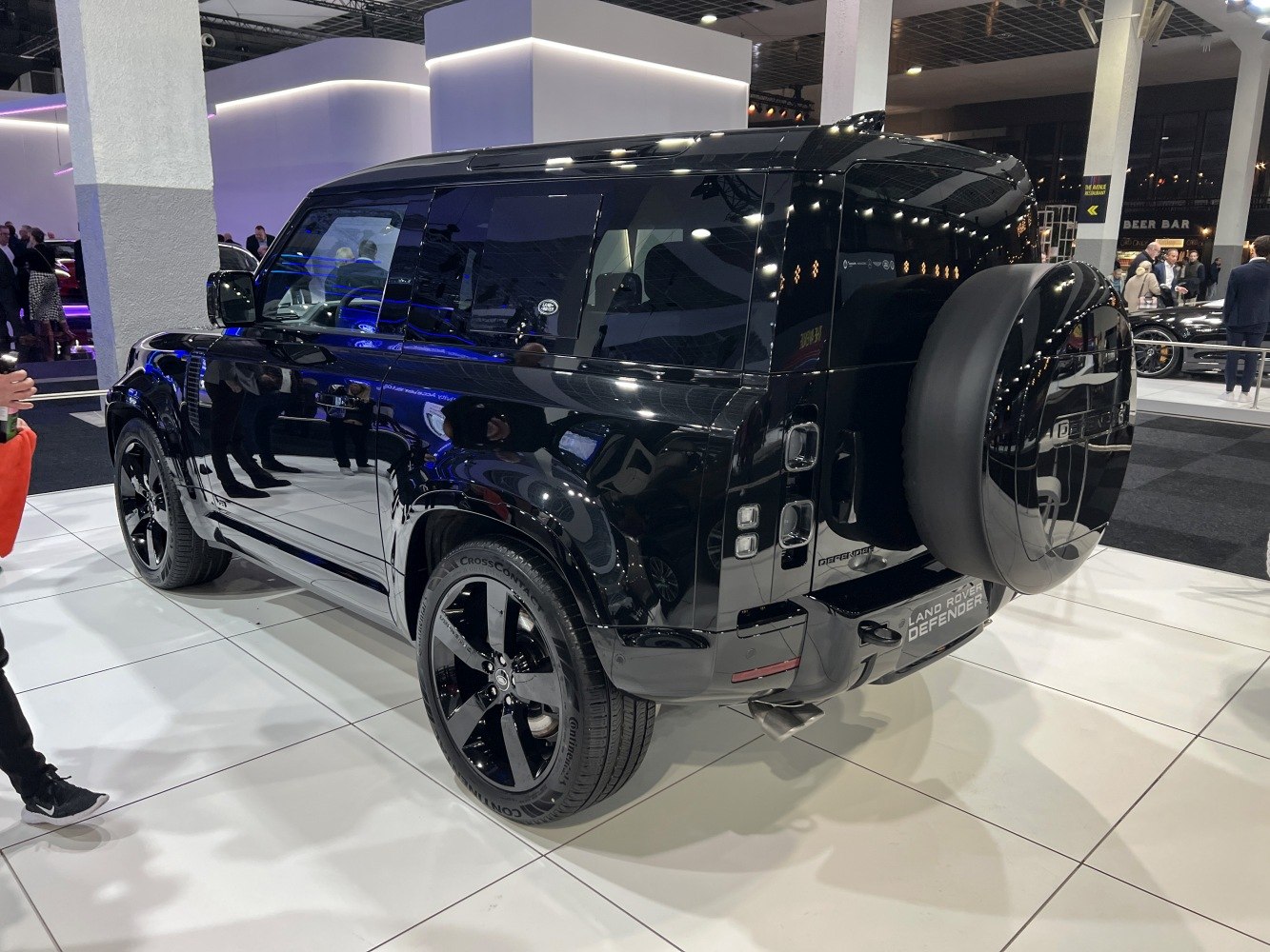 Glossy black modern SUV with rear spare wheel and tinted windows
