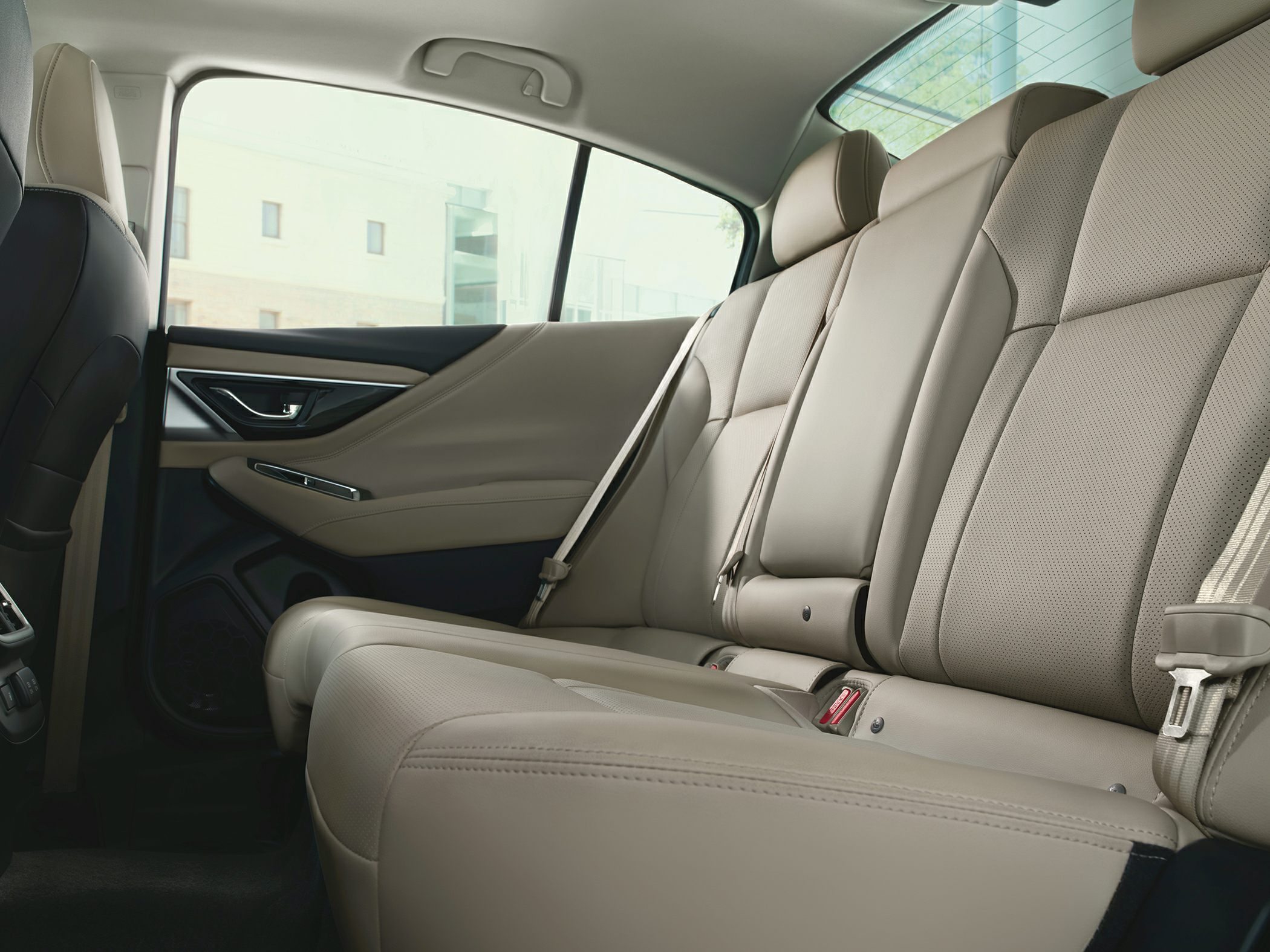 Beige leather rear seats with seatbelt and spacious legroom