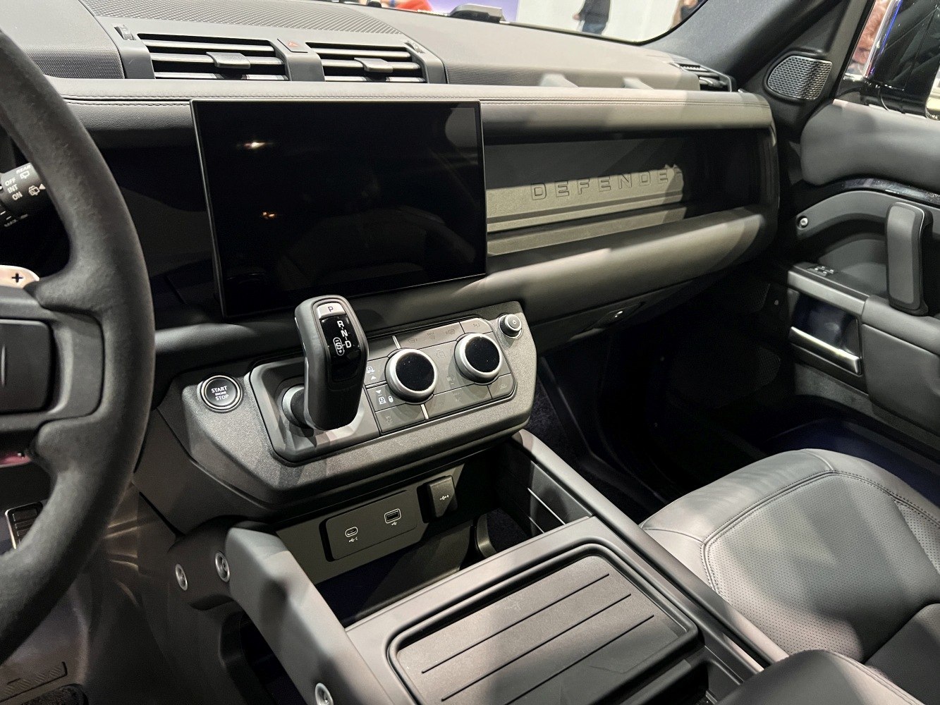 Touchscreen display and center console with gear selector and climate controls
