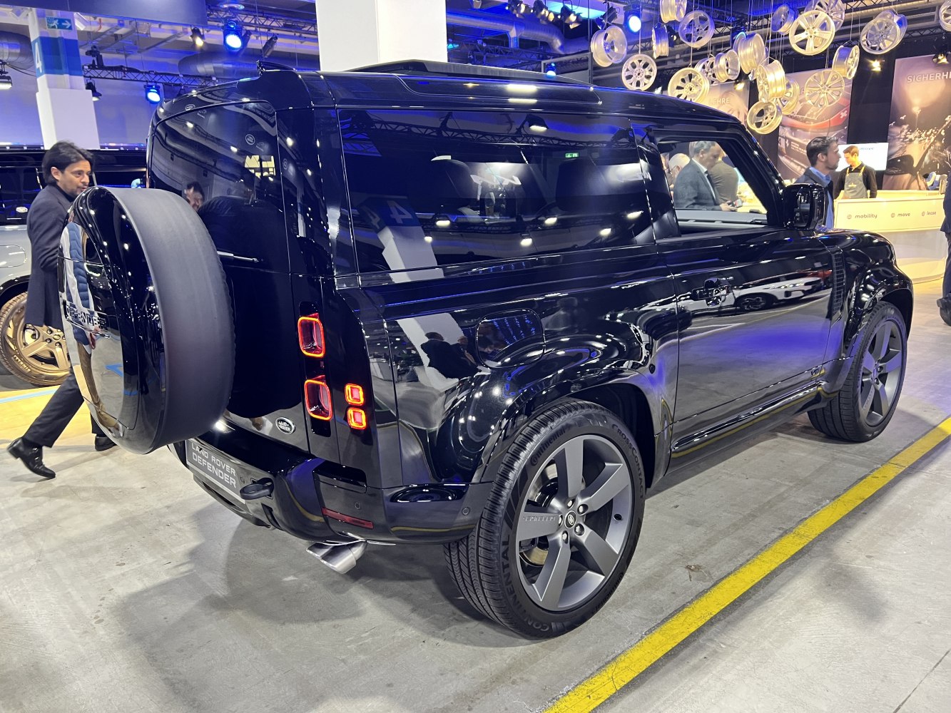 Rear view of black off-road SUV with spare wheel and distinctive tail lights.