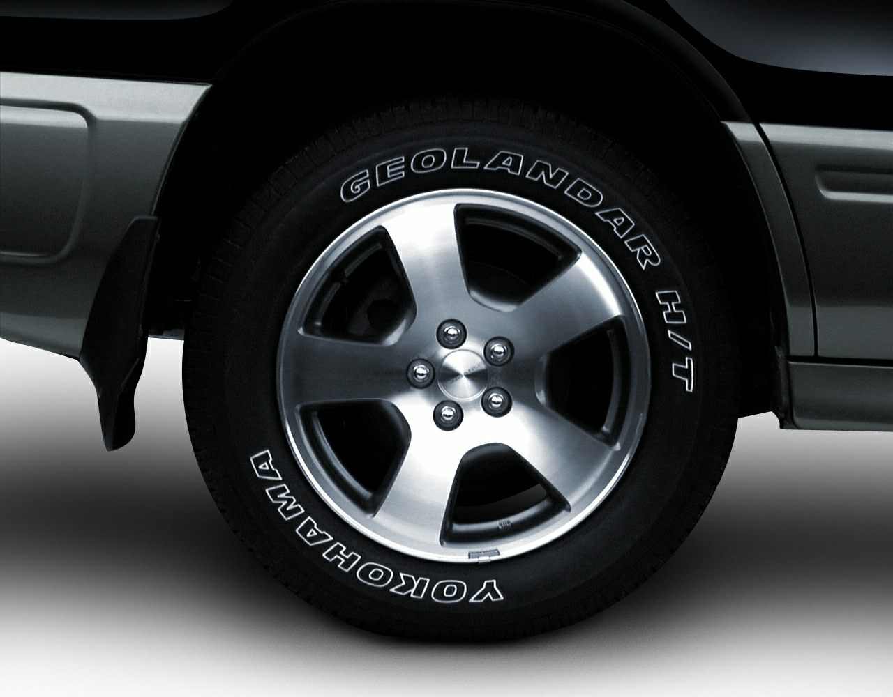 Alloy wheel with Yokohama Geolandar H/T tire on vehicle