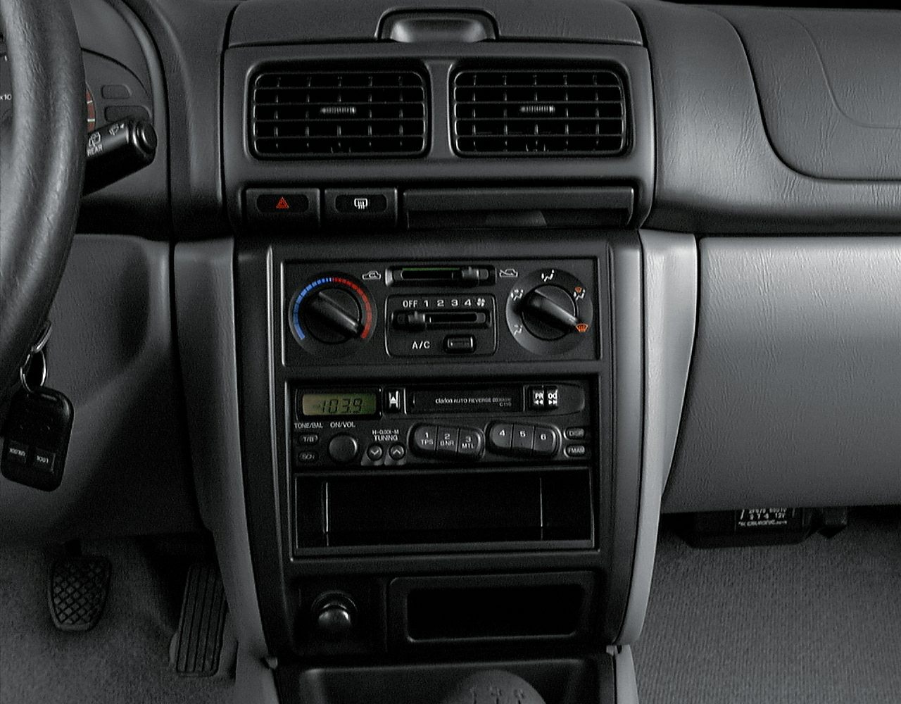 Dash with climate control knobs, vents, and classic radio unit
