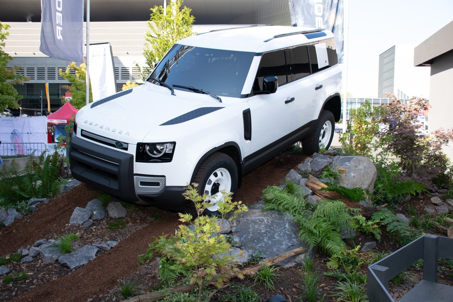 White SUV climbing rocky off-road terrain with rugged design