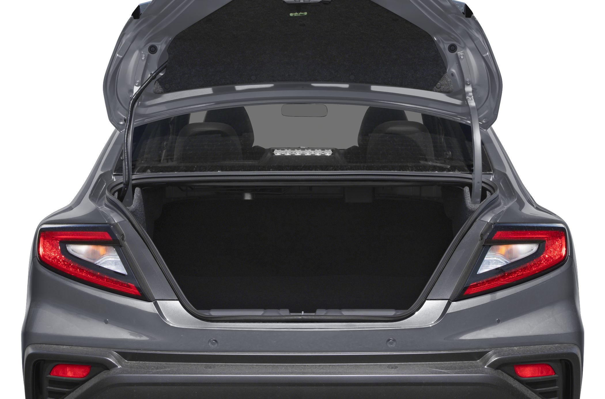 Open trunk with rear taillights and trunk interior of a modern sedan.