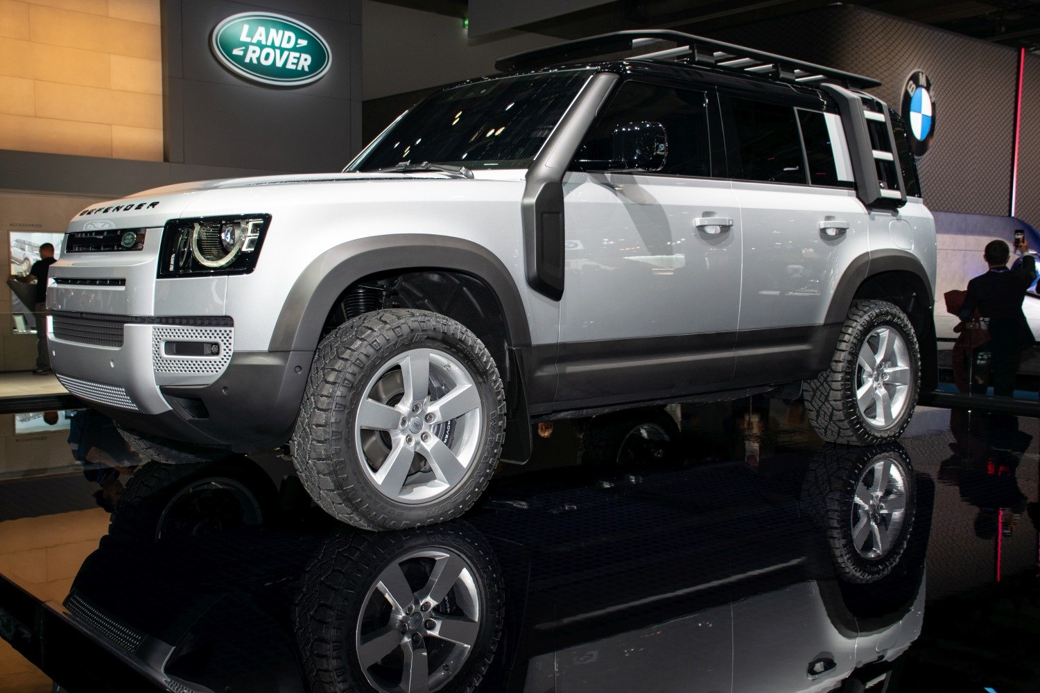 White SUV with snorkel, roof rack, and off-road tires