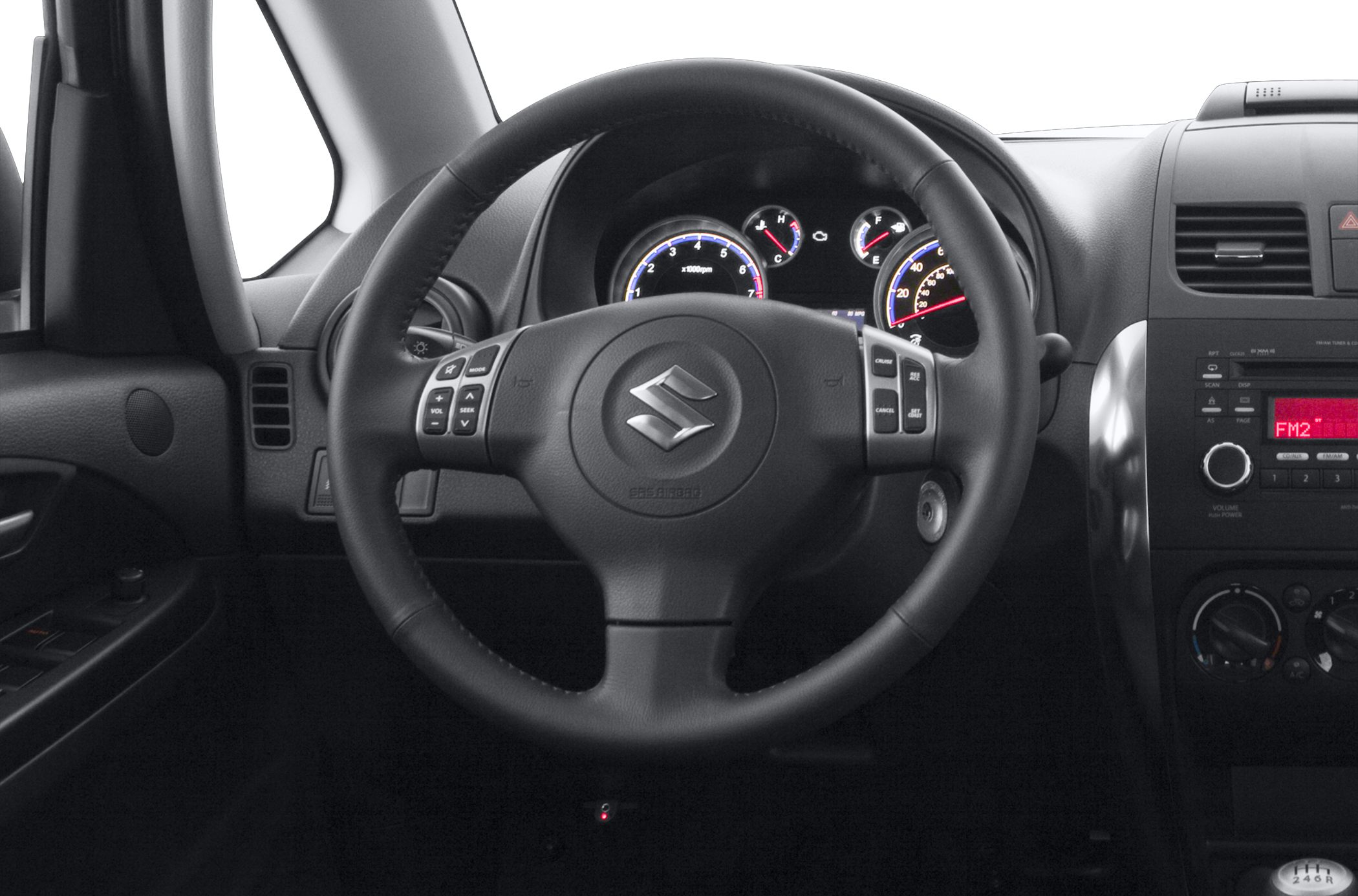 Steering wheel with audio and cruise control buttons and illuminated instrument cluster.