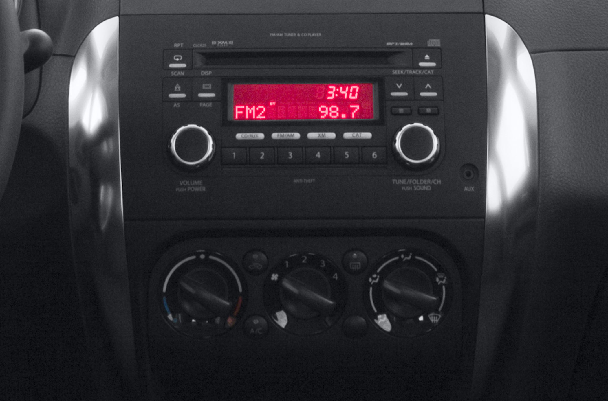 Radio and climate control panel with FM tuner and manual AC knobs