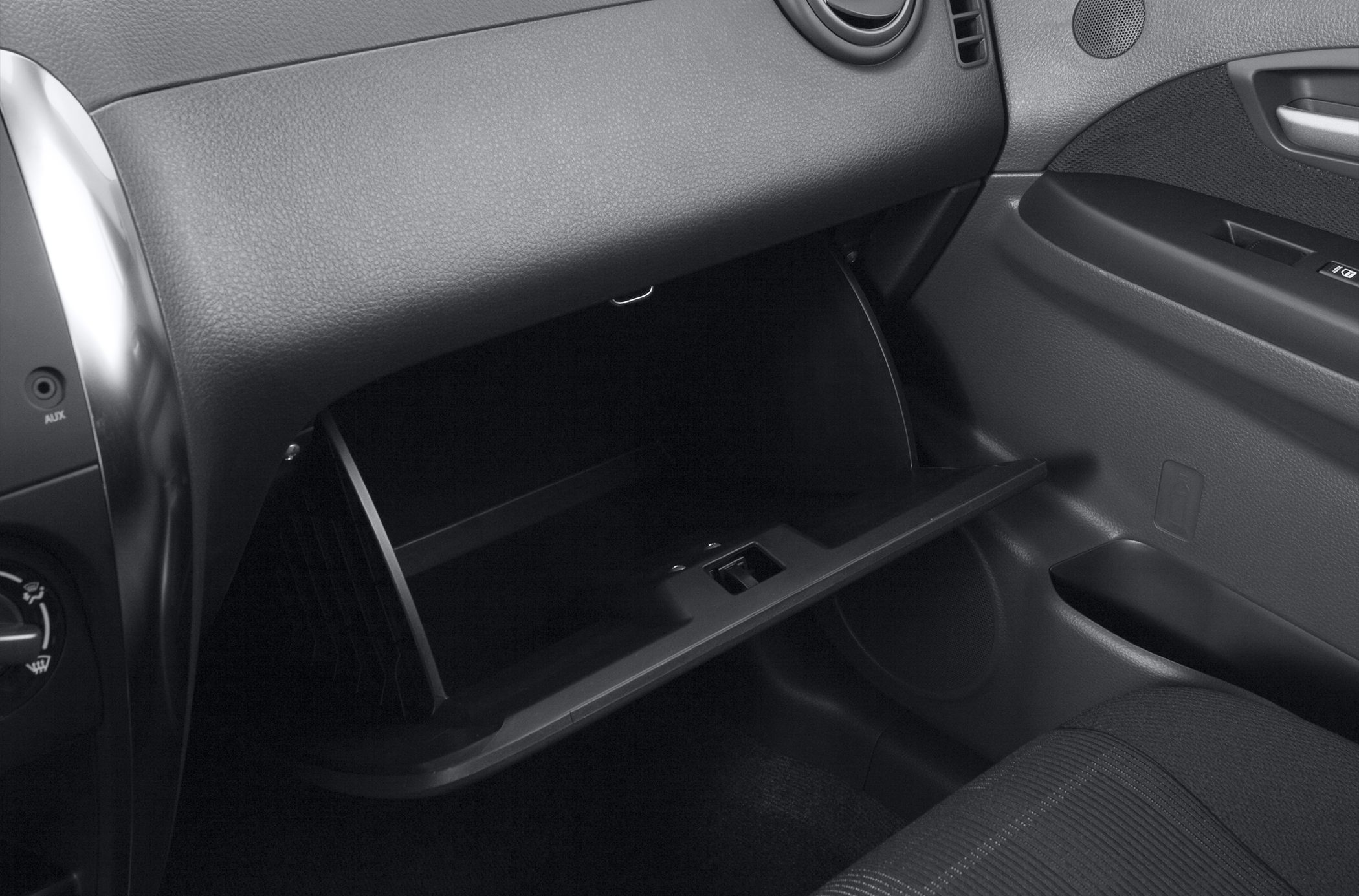 Open glove compartment in textured dashboard interior