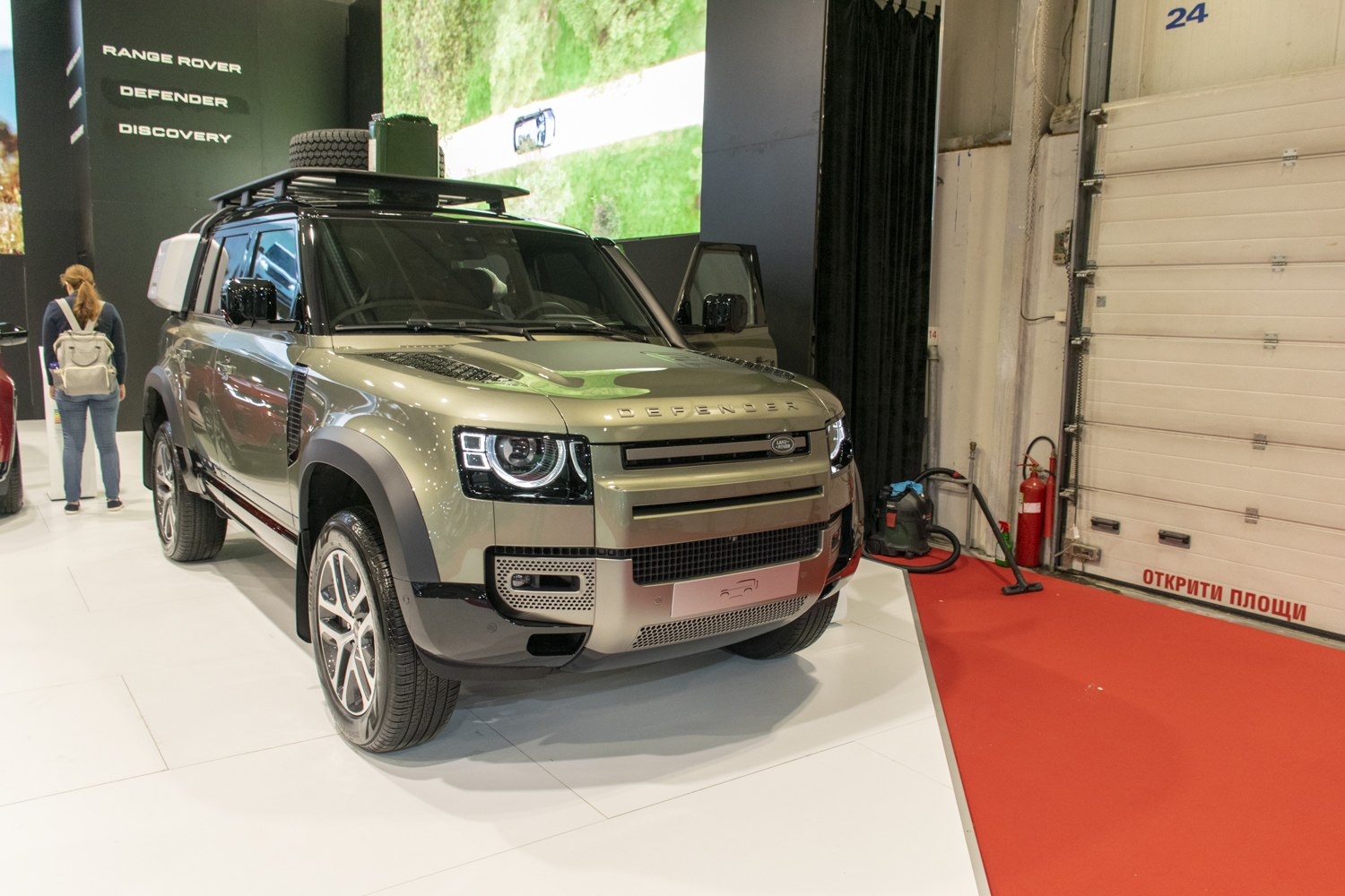 Front view of SUV with LED headlights and roof rack with spare tire