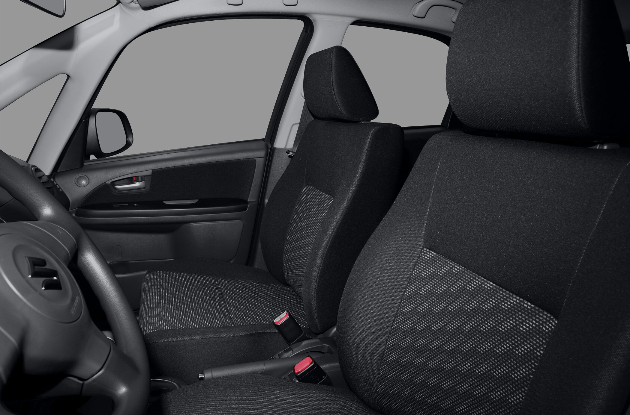 Front seats and door interior with seatbelt buckles and handbrake