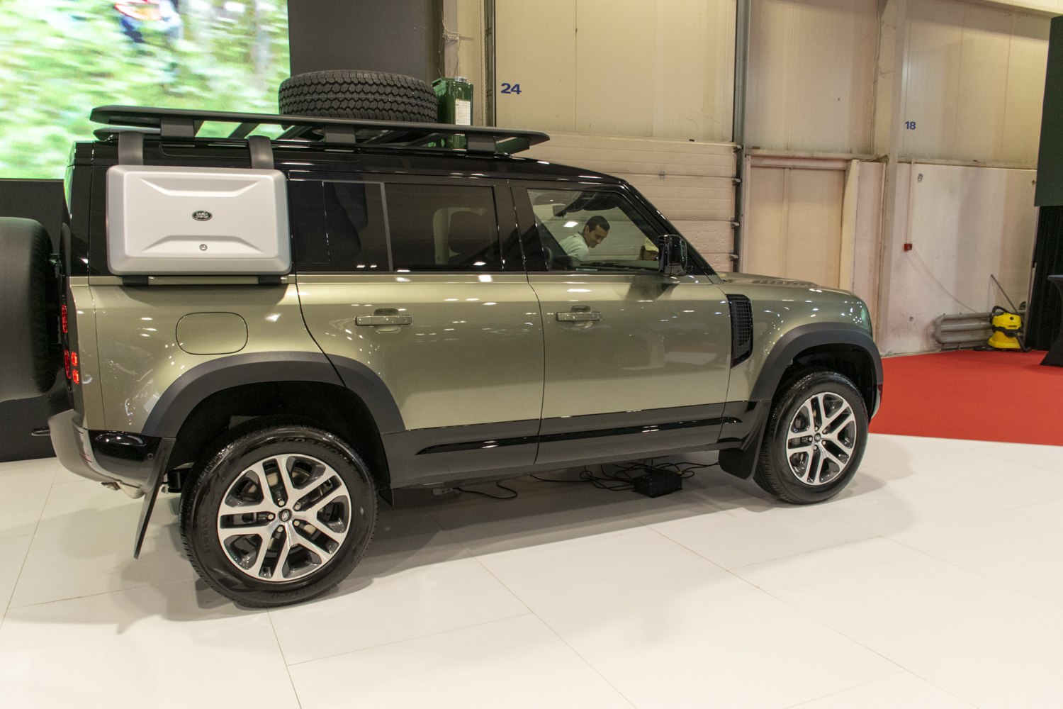 Side profile of SUV with roof rack and rear spare tire