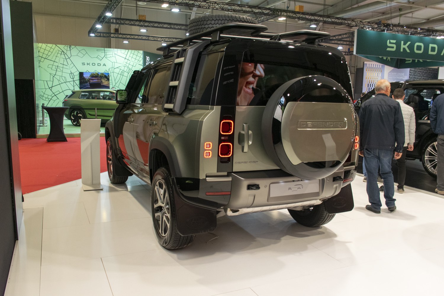 Rear view of SUV with roof rack and spare tire mounted.