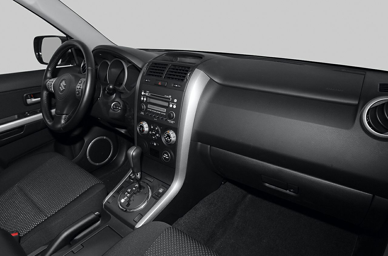 Car interior with dashboard, steering wheel, and center console.