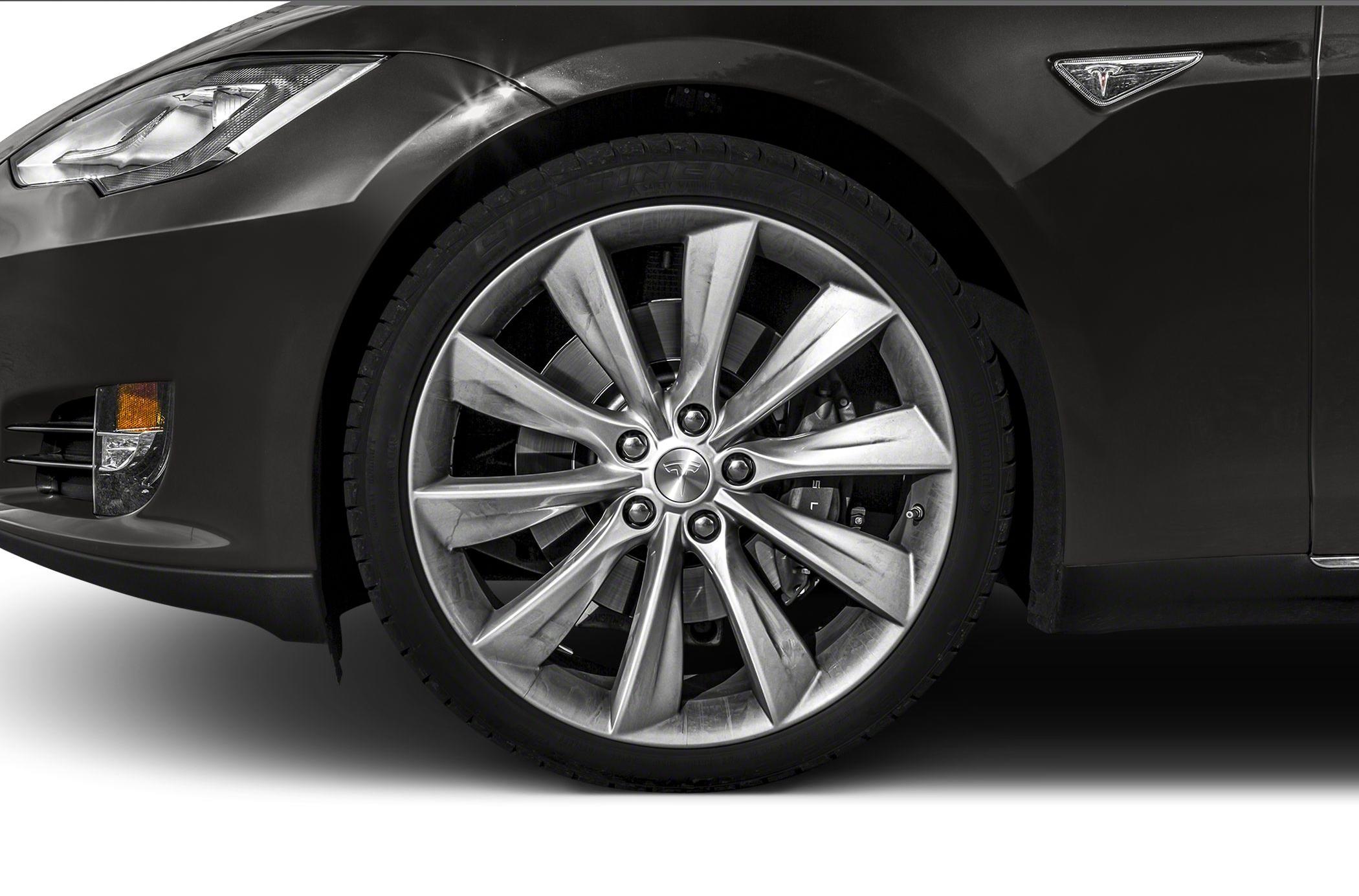 Close-up of front alloy wheel and front fender with Tesla badge