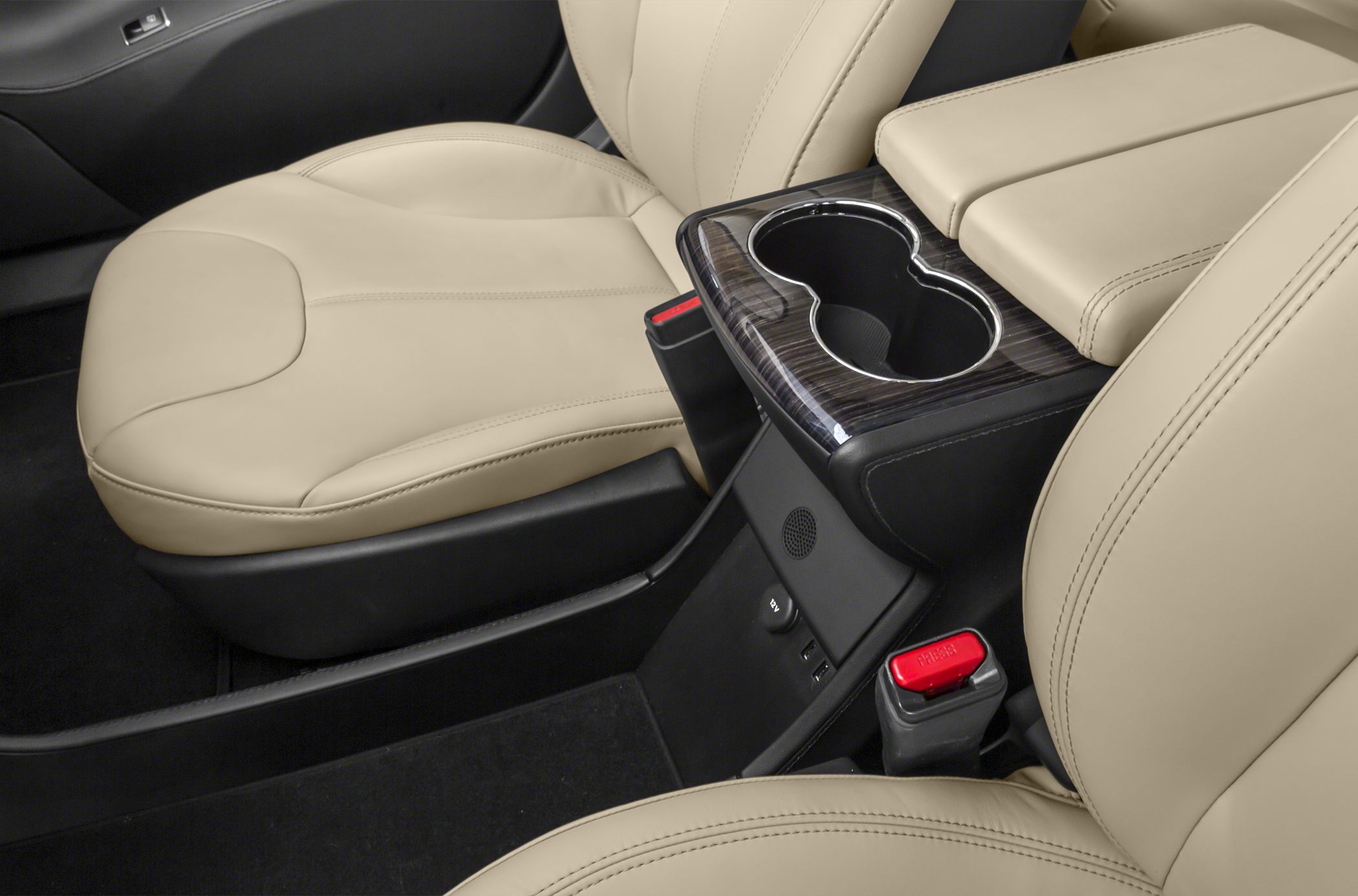 Beige leather seats with center console cup holders and armrest
