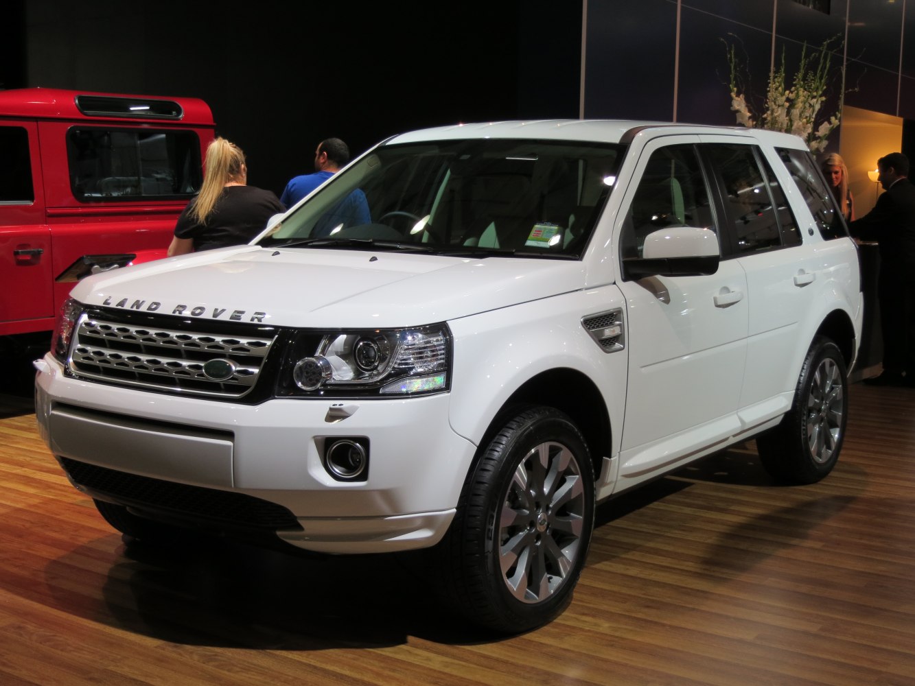 Front and side view of an SUV with distinctive headlights and grille