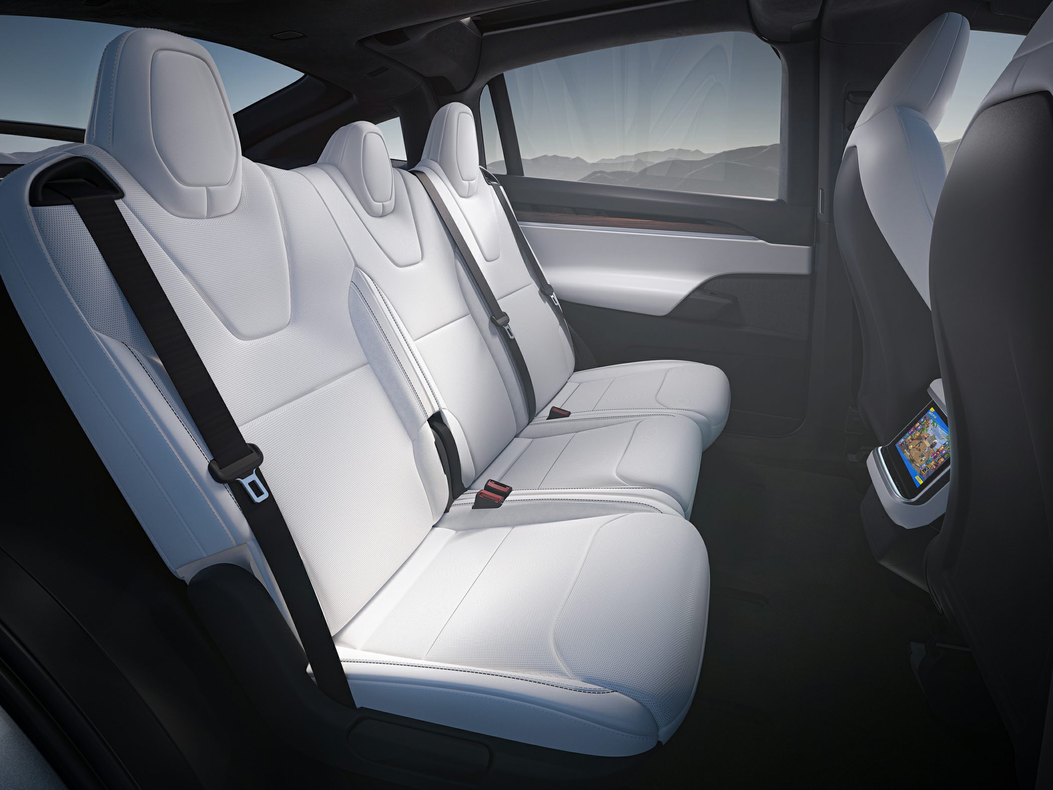 White rear seats with integrated seat belts and modern car interior design