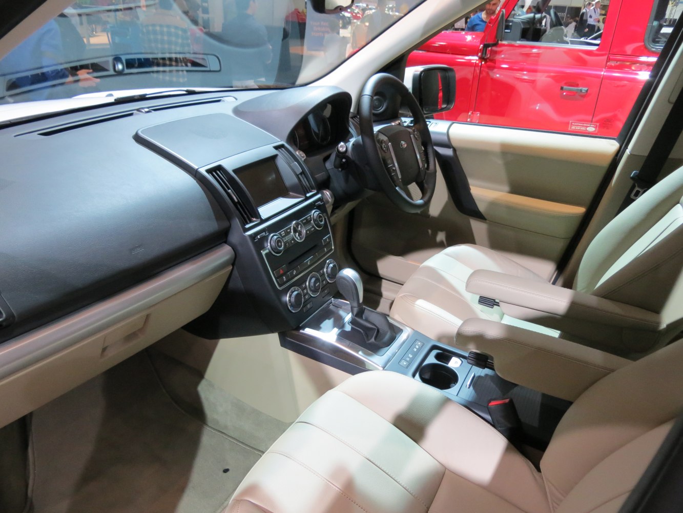 Beige leather seats and modern dashboard with automatic gear shift