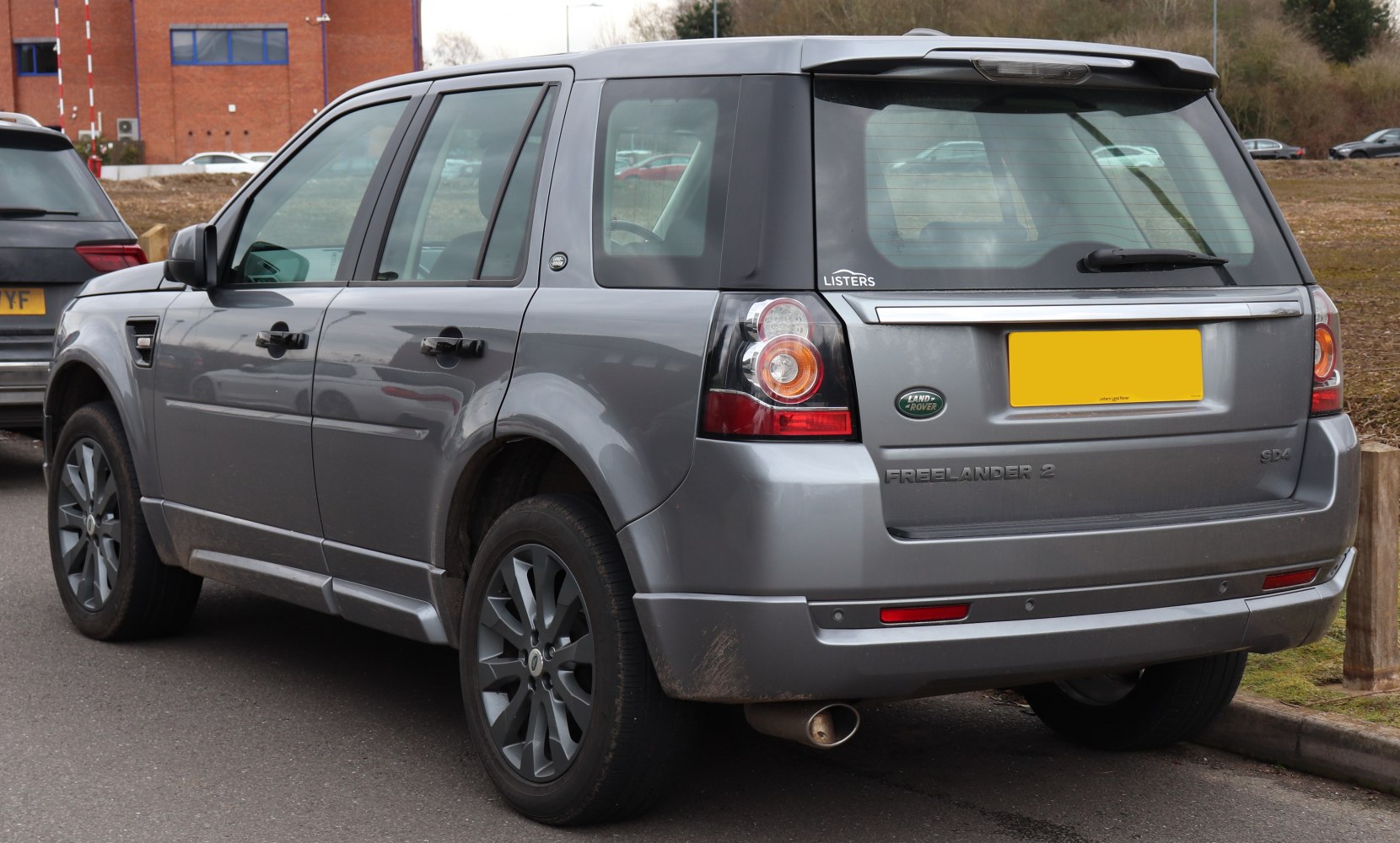 Rear view of silver SUV with distinct tail lights and rear trim.