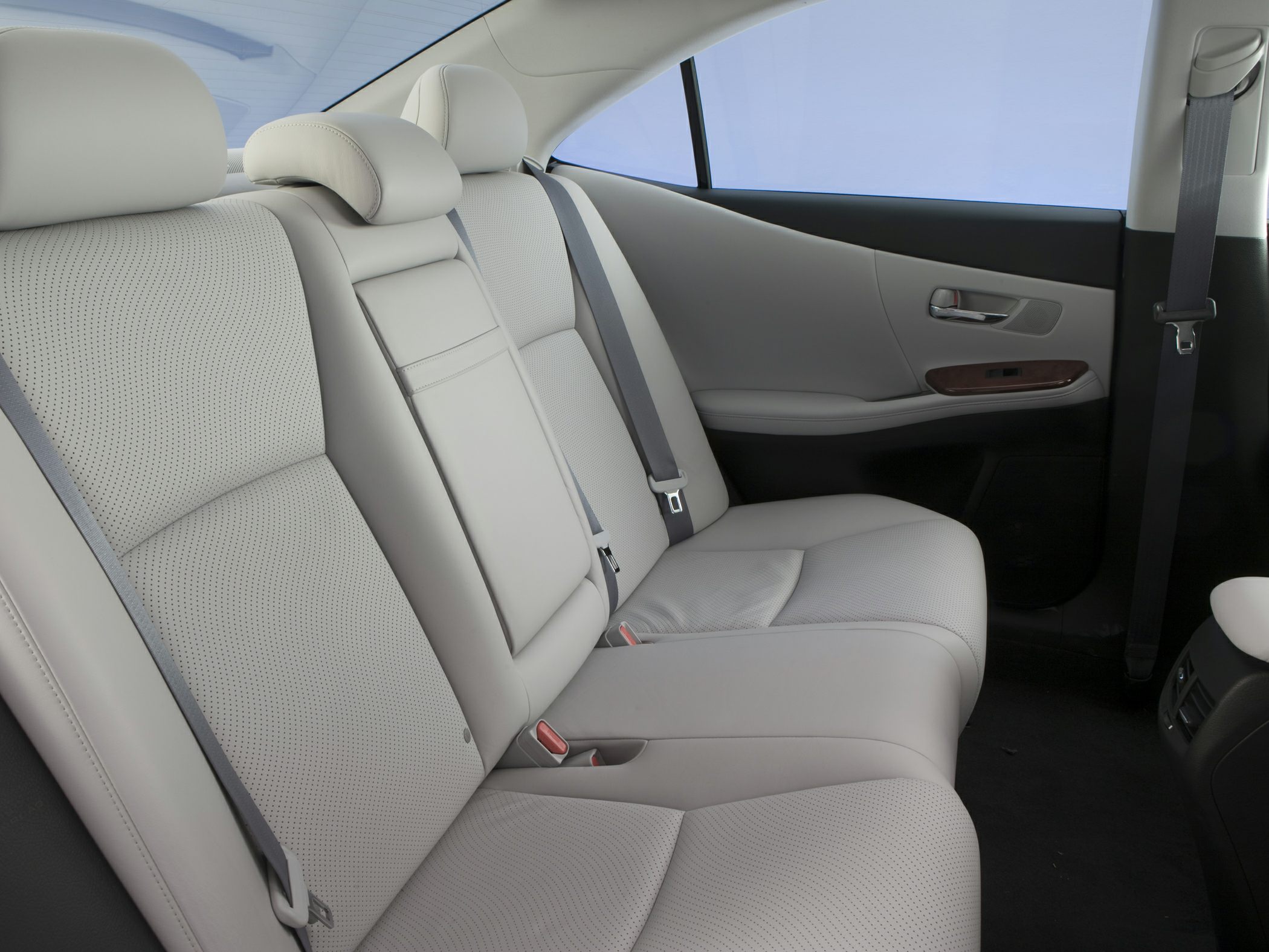 Rear seat with light perforated leather upholstery and seat belts