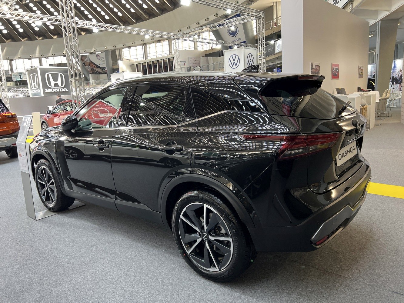 Rear-side view of a black SUV with alloy wheels and tinted windows