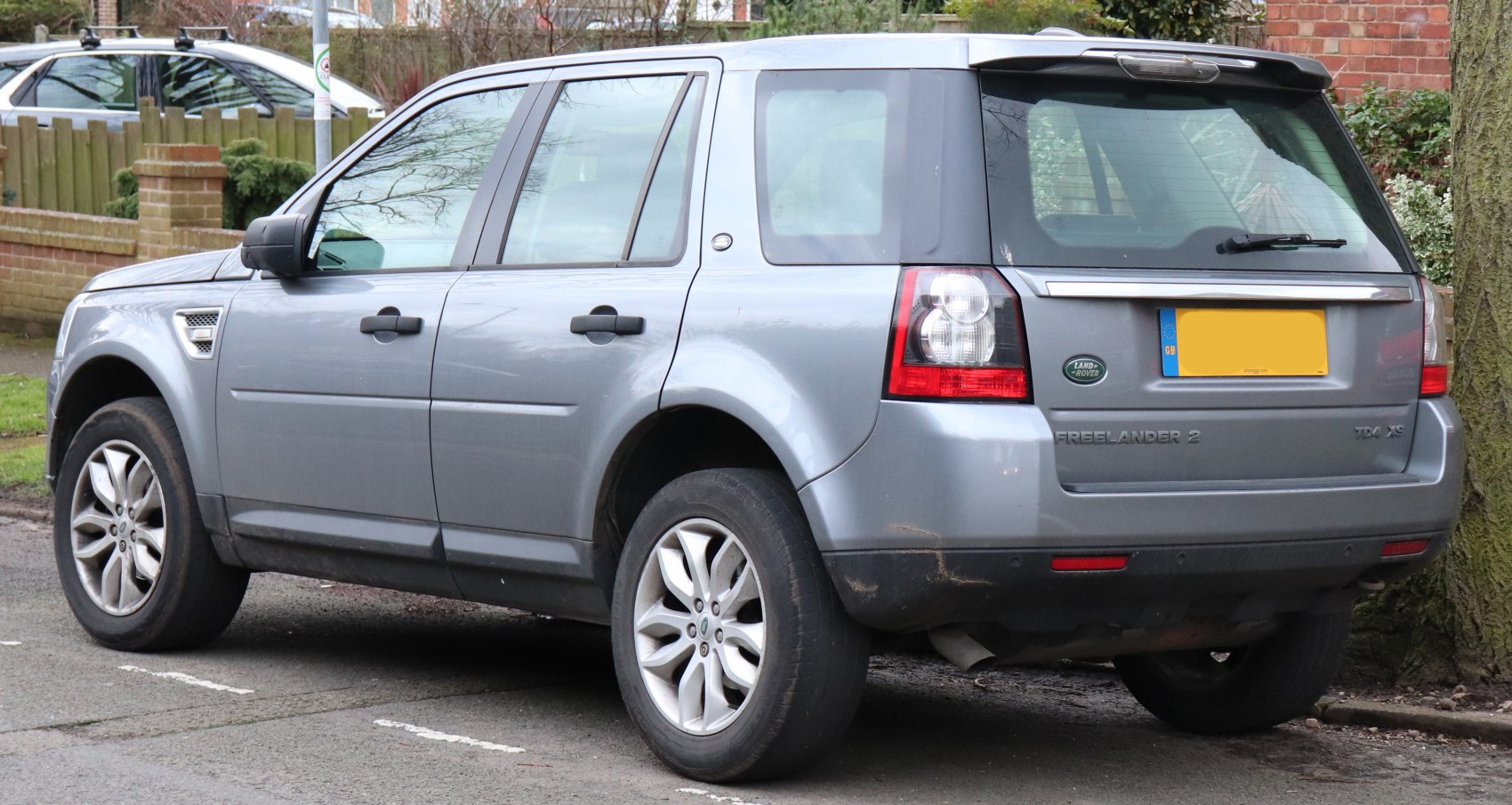 Gray midsize SUV rear side with alloy wheels and distinct taillights