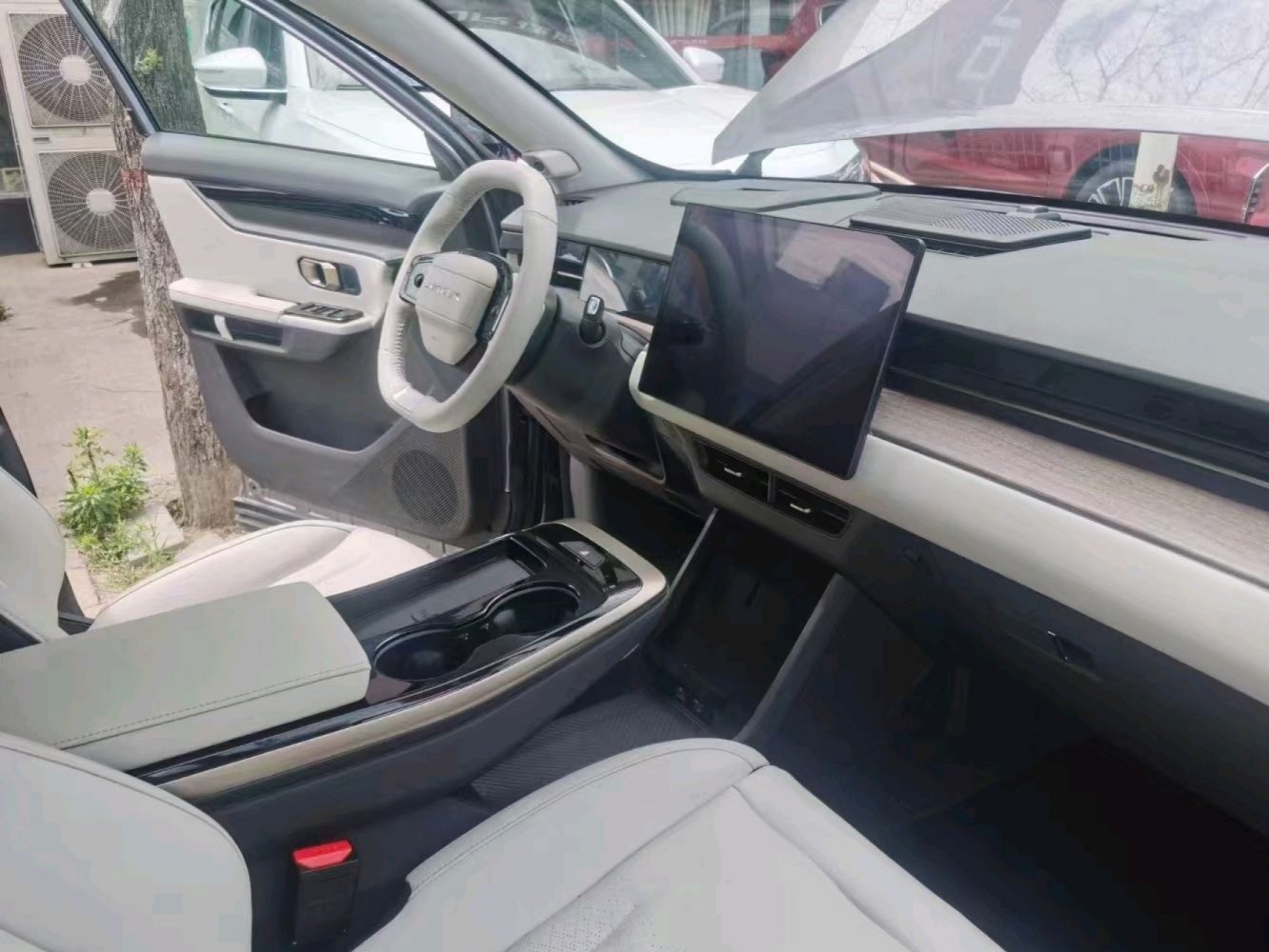 Large touchscreen and modern dashboard with steering wheel and center console