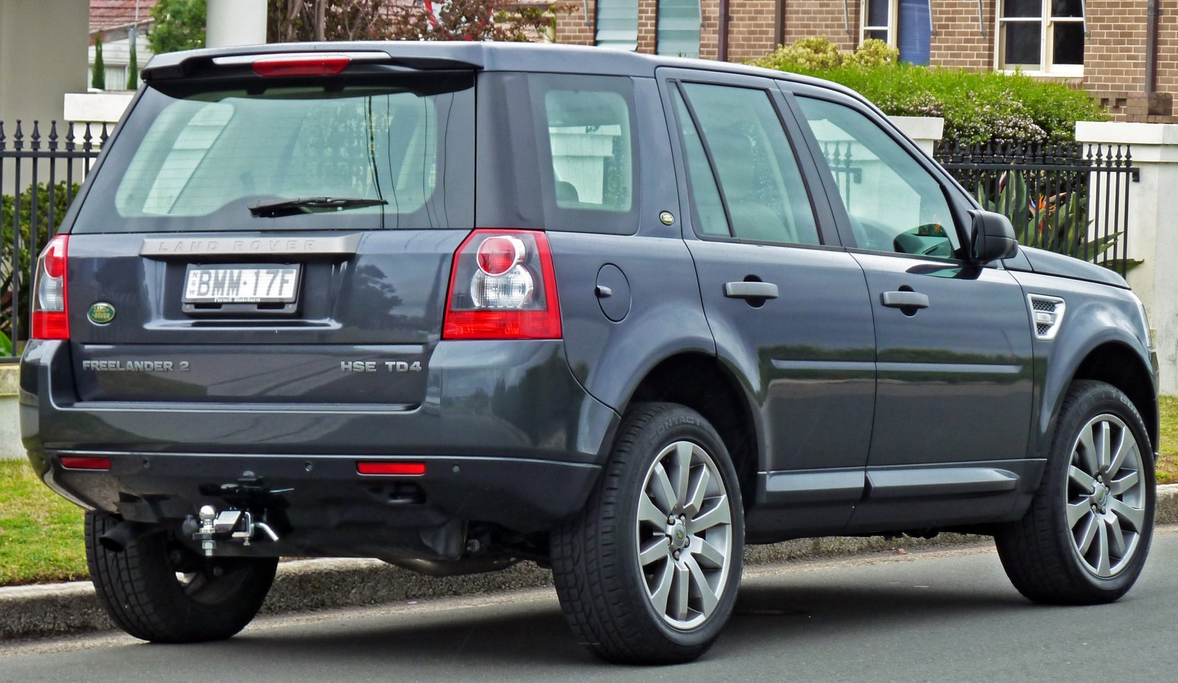 SUV rear and side view with tow hitch and alloy wheels