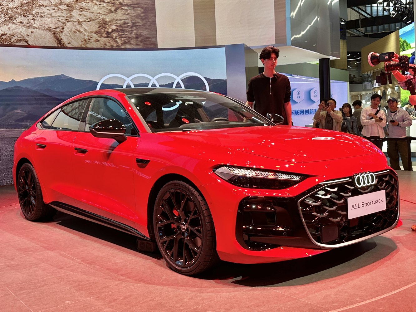 Bold red sportback with dynamic LED headlights and distinctive black alloy wheels