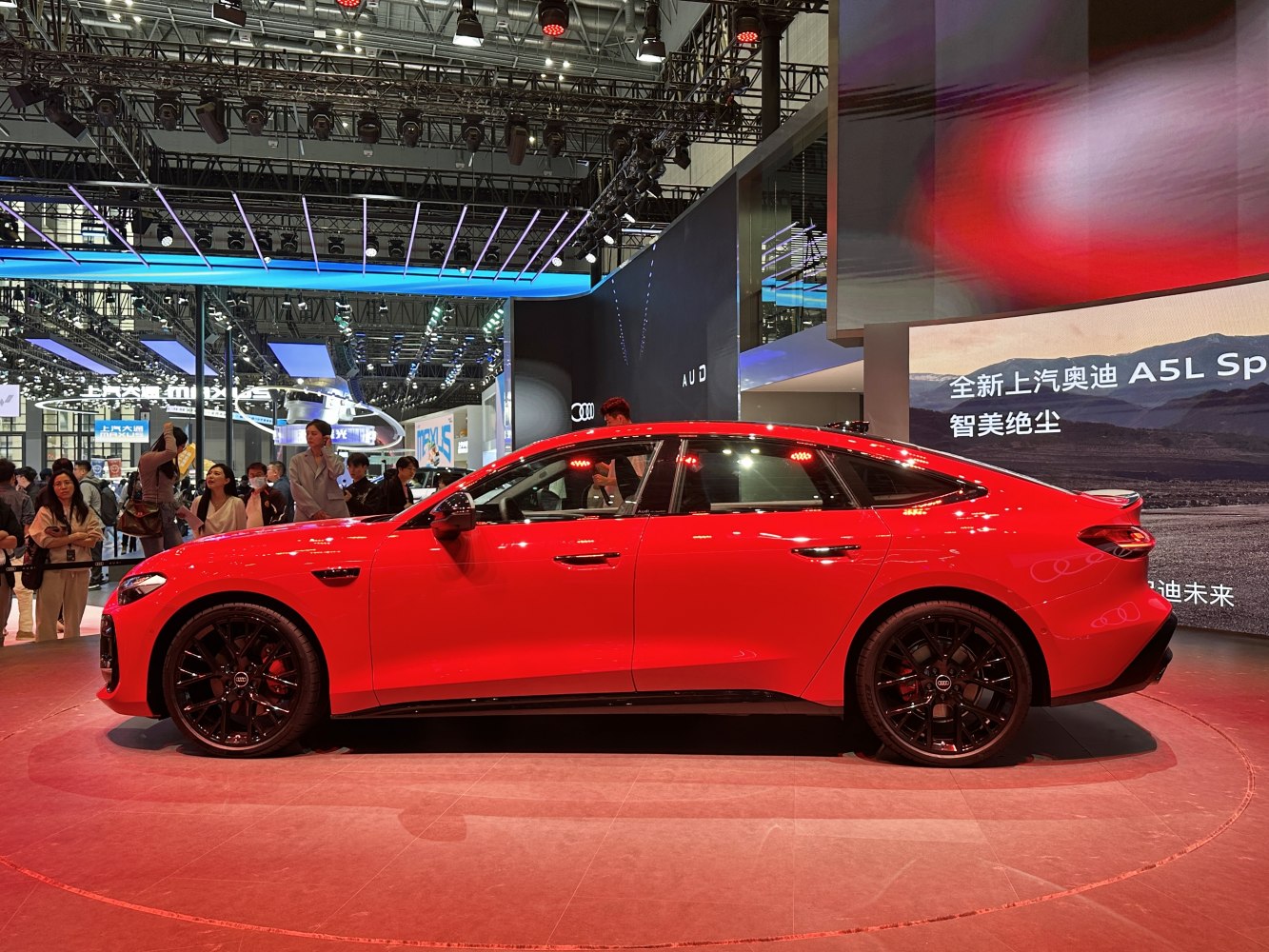 Red sportback with black wheels and aerodynamic side profile