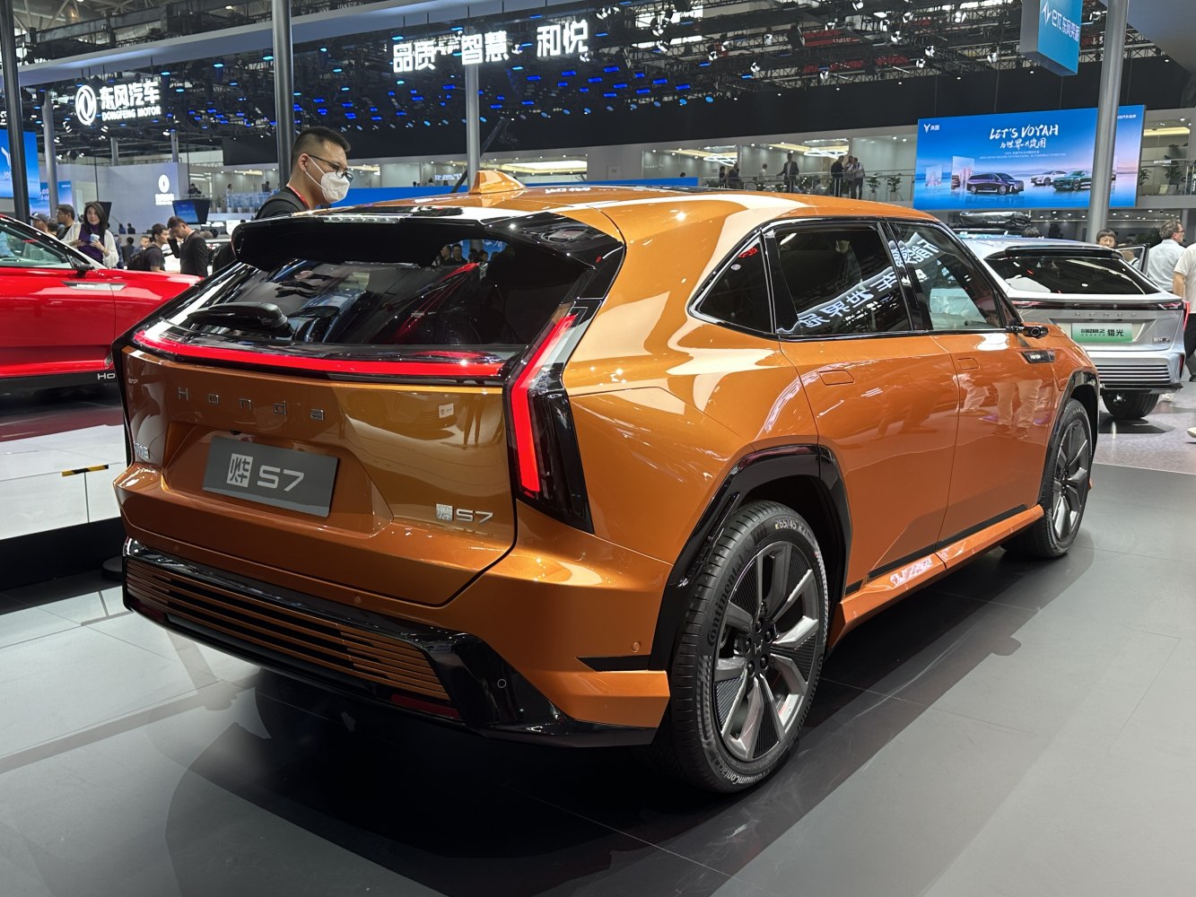 SUV rear corner with bold taillights and sporty wheels in metallic orange