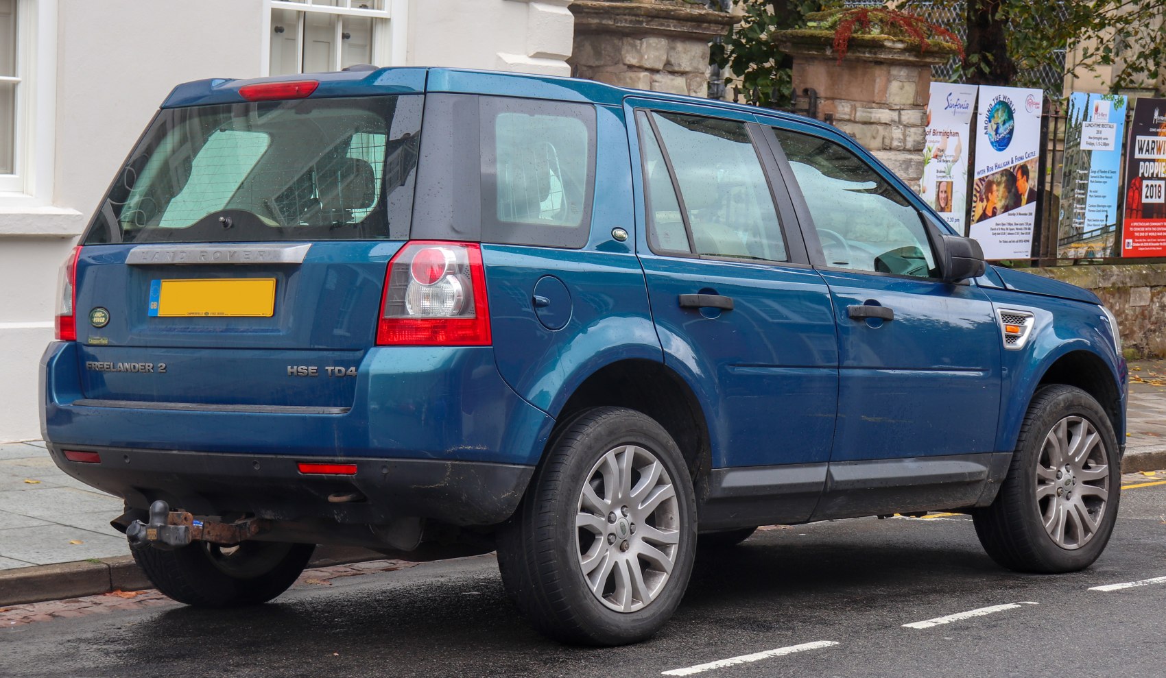 Rear and side profile of blue SUV with distinct alloy wheels and rear lights