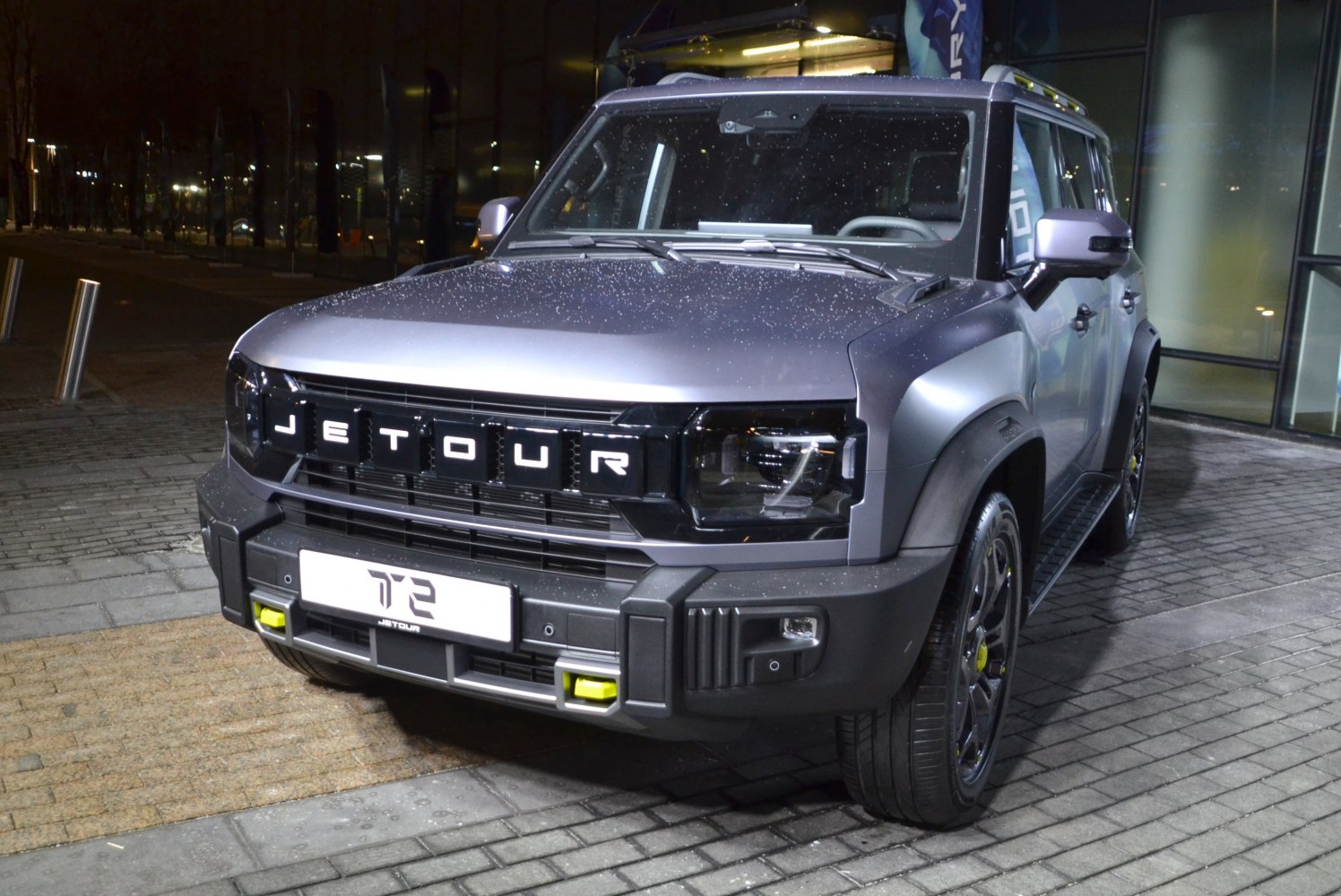 SUV front with bold grille and LED headlights at night