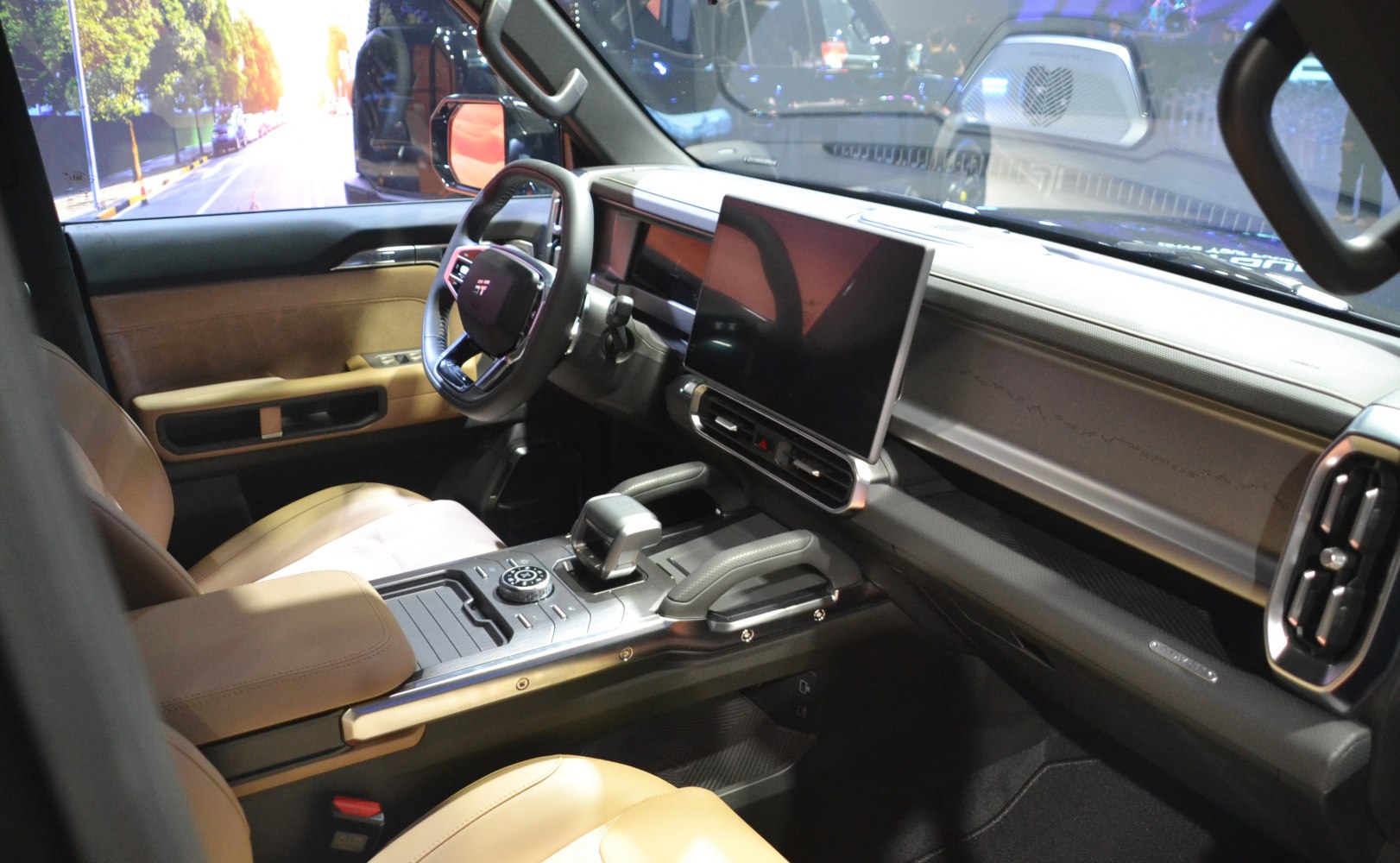 Modern dashboard and large touchscreen infotainment system with tan leather seats
