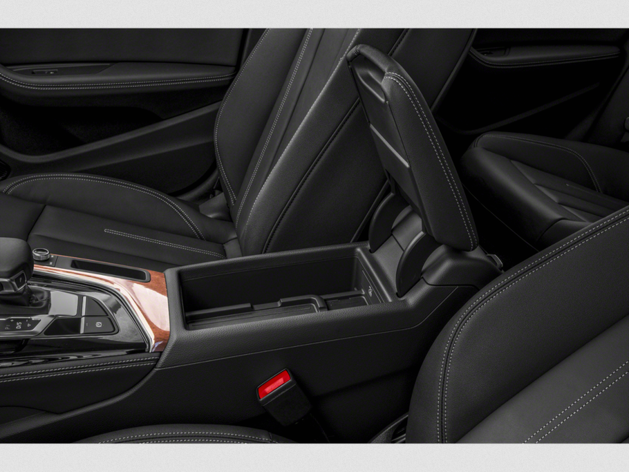 Center console with gear selector and storage compartment in black leather interior