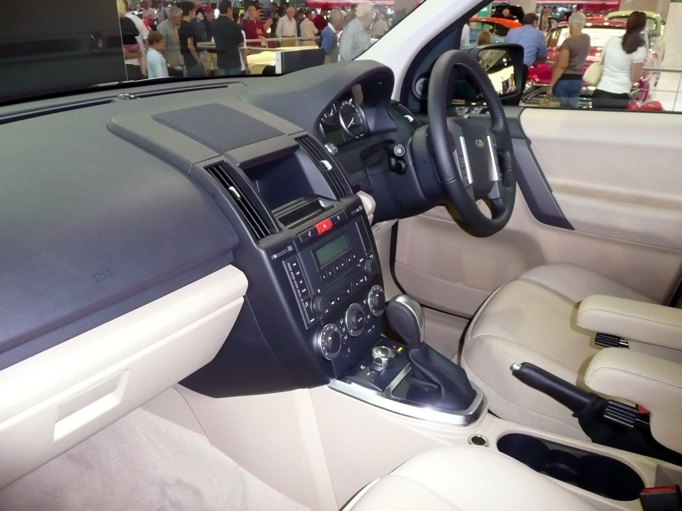 Dashboard and center console with steering wheel and beige seats