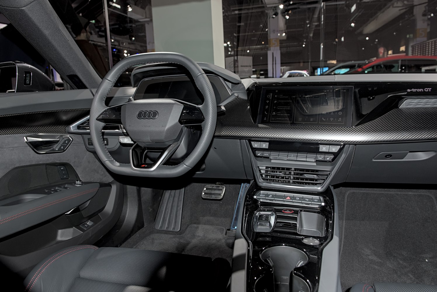 Digital instrument cluster and carbon fiber dashboard trim in a modern luxury interior.